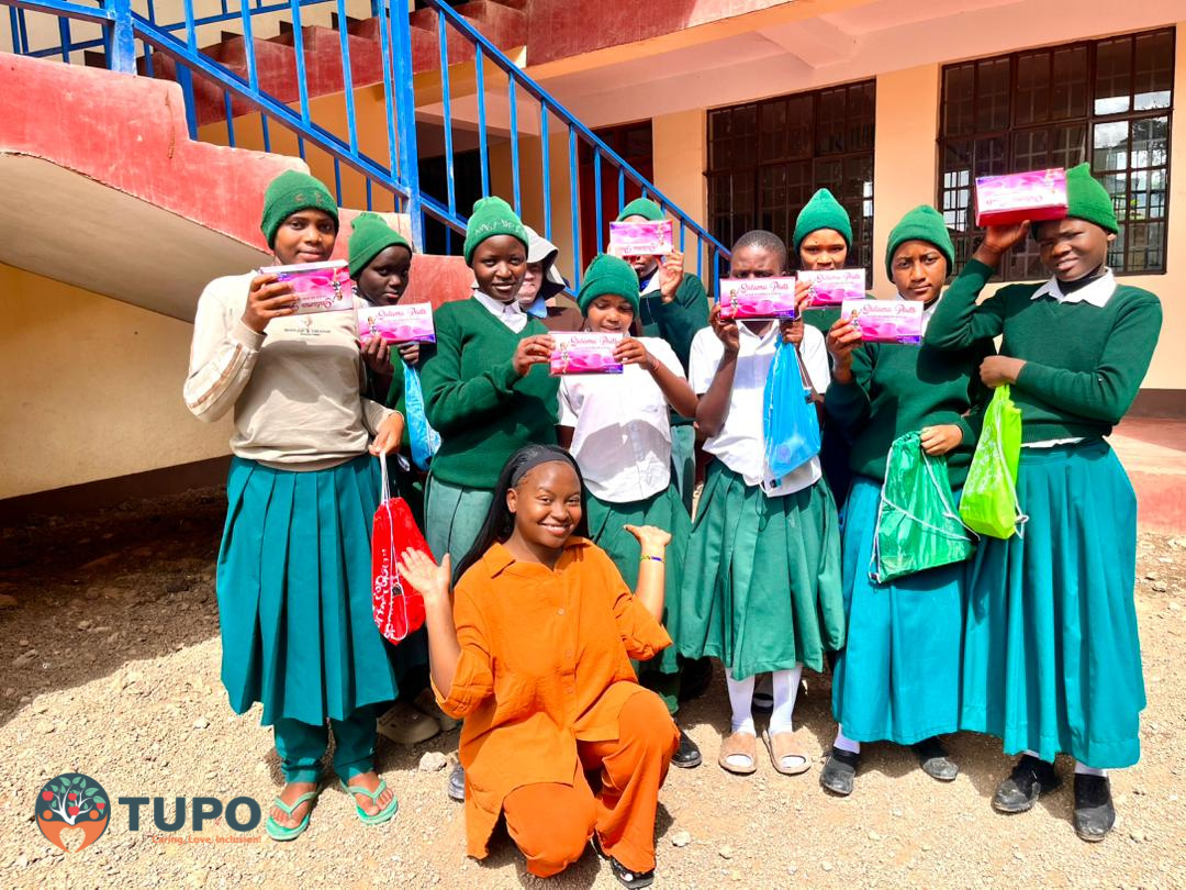 Smiling schoolgirls with Salama Pads dignity packs